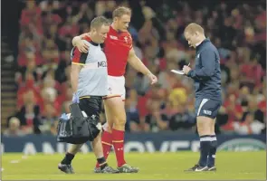  ?? Picture: Getty ?? Wales centre Cory Allen is helped off after tearing his hamstring
