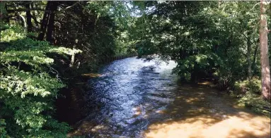  ??  ?? A view of the Pomperaug River in Woodbury, in the area where state police Sgt. Brian Mohl died while on duty during the storm on Thursday.