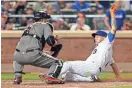  ?? ADAM HUNGER/AP ?? The Mets’ Asdrubal Cabrera is tagged out by Diamondbac­ks catcher Chris Iannetta during the seventh inning on Monday in New York. The D-Backs ended a three-game losing streak.