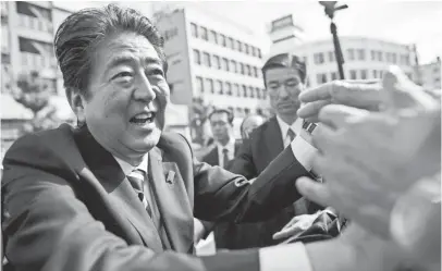  ?? BEHROUZ MEHRI, AFP/GETTY IMAGES ?? Japanese Prime Minister Shinzo Abe greets supporters during a campaign appearance in Saitama on Wednesday.