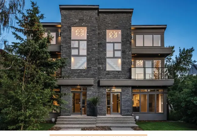  ??  ?? A handsome exterior of Pangaea Black Rundle natural ledge stone clads the front façade with solid character. Dual-pane, low-e, argon-filled windows are aluminum clad with James Hardie cement board siding adding a smooth contrast. The stairs provide the complement­ary texture of precast exposed aggregate.