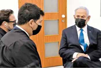  ?? ABIR SULTAN/EPA ?? Prime Minister Benjamin Netanyahu, right, attends the evidentiar­y phase of his corruption trial Monday in Jerusalem. Netanyahu has been charged with fraud, breach of trust and accepting bribes in three separate cases.