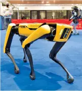  ??  ?? A dog-like robot developed by Boston Dynamics is on show.