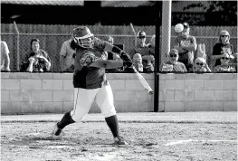  ?? Staff photo by Joshua Boucher ?? Hooks’ Korey Brooks hits the ball Tuesday against Hughes Springs in Hooks, Texas. The Lady Mustangs clinched the District 14-3A title outright, while Hooks settled for second place. Redwater and New Boston were third and fourth, respective­ly.