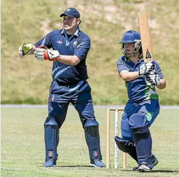  ?? PHOTO: KEVIN STENT/STUFF ?? Petone-Eastbourne’s Kieran Butler tries to pierce the field, watched by Johnsonvil­le wicketkeep­er Scott Mudgway.