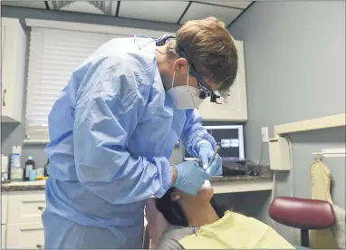  ?? BEN HASTY— READING EAGLE ?? Dr. Jordan Hottenstei­n checks patient Jodi Miller’s teeth at Central Berks Dental Center in Leesport.