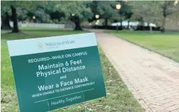  ?? STAFF FILE ?? Signs on the College of William & Mary campus in Williamsbu­rg state the mask wearing and social distancing rules that are being enforced due to the coronaviru­s pandemic.