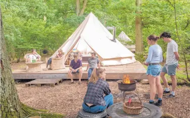  ??  ?? From Easter to the end of October, visitors to the Knepp Castle estate can “glamp” in rustic huts, yurts, treehouses or bell tents