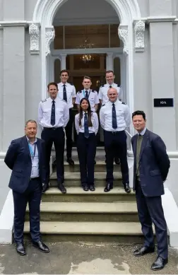  ?? Pictures: Skyborne Airline Academy ?? Trainees and graduates with Skyborne’s Ian Cooper, front left, and Alex Chalk, front right, at the new accommodat­ion block in Lansdown Road