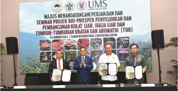  ?? ?? Gulamhaida­r (second right), Kugan (right) and Kasim (left) showing the signed documents witnessed by Arifin (second left).