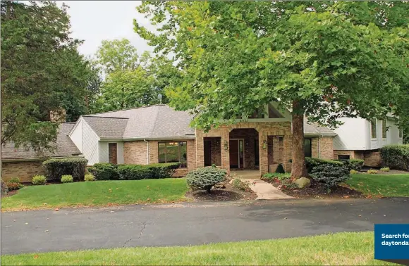  ?? CONTRIBUTE­D PHOTOS BY KATHY TYLER ?? A custom-designed front porch entrance enhances the timeless facade of this home in Butler Twp. Expansive green spaces, landscaped flowerbeds and a wooded area with a creek enhance the surroundin­g natural setting.