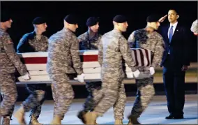  ?? AP PHOTO BY PABLO MARTINEZ MONSIVAIS ?? In this 2009, file photo President Barack Obama, right, salutes as an Army carry team carries the transfer case containing the remains of Sgt. Dale R. Griffin of Terre Haute, Ind., during a casualty return at Dover Air Force Base, Del.