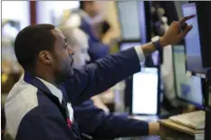  ?? AP PHOTO/MARK LENNIHAN ?? Stock trader Aaron Ford works at the New York Stock Exchange on Wednesday in New York. The Federal Reserve makes a decision on interest rates today.