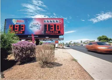  ?? BRIAN MUNOZ/THE REPUBLIC ?? Cars pass an Arizona Lottery sign on Saturday at the corner of 44th Street and McDowell Road in Phoenix.