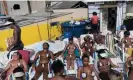  ?? Photograph: Renata Brito/AP ?? Women in search of marquinha de fita wear bikinis created from black electrical tape at the Erika Bronze rooftop salon in the suburb of Realengo in Rio de Janeiro, Brazil, in 2017.