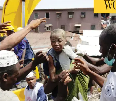  ?? SUNDAY ALAMBA / THE ASSOCIATED PRESS ?? A child is pulled from the rubble of a collapsed building in Lagos on Wednesday which housed a school with up to 100 children inside. The three-storey school building collapsed while classes were in session.