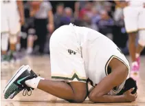  ?? JOSE CARLOS FAJARDO/ STAFF ?? Moreau’s Kyree Walker drops to the floor after getting hit in the face while playing Esperanza in the Division II state championsh­ip in Sacramento. Esperanza defeated Moreau 72-65.
