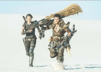  ?? SONY PICTURES ?? Milla Jovovich, left, and Tony Jaa star in Monster Hunter, a dull and familiar tale of survival in a sci-fi wasteland.