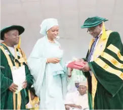  ??  ?? Hadiza Bala Usman, MD NPA, receiving the Posthomous Honarary Doctorate Degree conferred on her father from VC of FUK, Prof. Alhassan Gani yesterday at Kashere