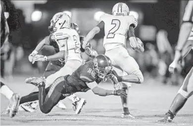  ?? BILLY HARDIMAN/SPECIAL FOR AZCENTRAL SPORTS ?? Peoria Centennial free safety Isaac Haney attempts to tackle Glendale Apollo quarterbac­k Taz Middleton on Friday night.