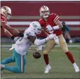  ?? NHAT V. MEYER — BAY AREA NEWS GROUP ?? The Dolphins’ Emmanuel Ogbah
( 91) knocks the ball out of 49ers quarterbac­k C. J. Beathard’s hands for a turnover at Levi’s Stadium in Santa Clara on Oct. 10.