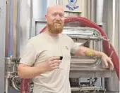  ?? PHILLIP VALYS/SUN SENTINEL ?? Corey Artanis is the founder and head brewer behind 3 Sons Brewing Company, which opened in March.