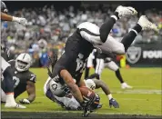  ??  ?? Oakland Raiders’ Marshawn Lynch flips onto his feet after scoring a second-quarter touchdown against the Broncos.