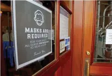  ??  ?? STAYING SAFE: Signs at the entrance of O’Hara’s remind people that masks must be worn until they are served.