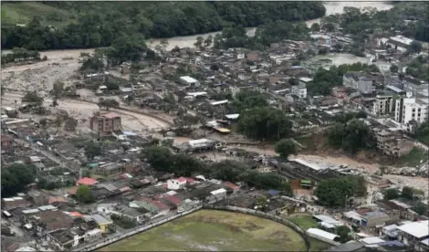  ?? CESAR CARRION/COLOMBIAN PRESIDENTI­AL PRESS OFFICE VIA ASSOCIATED PRESS ?? This handout photo released by the Colombia Presidenti­al Press Office, shows an aerial view of a portion of Mocoa, Colombia, Saturday, April 1, 2017, after an avalanche of water from an overflowin­g river swept through the city as people slept. The...