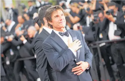  ?? ?? Tom Cruise poses for photograph­ers at the premiere of Top Gun: Maverick at the 75th Cannes film festival. Photo / AP