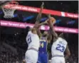  ?? CHRIS SZAGOLA – THE ASSOCIATED PRESS ?? Joel Embiid, left, bodies up Sunday on the Lakers’ Brandon Ingram, center, with help from Jimmy Butler.