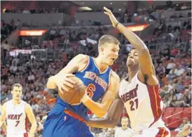  ?? HECTOR GABINO/TNS ?? The Knicks’ Kristaps Porzingis goes to the basket against Miami’s Hassan Whiteside on Monday night. Porzingis was picked No. 4 in the draft, a spot ahead of the Magic’s pick.