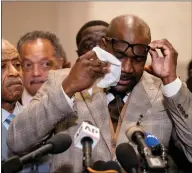  ??  ?? Philonise Floyd, brother of George Floyd, wipes tears from his eyes as he speaks during a news conference