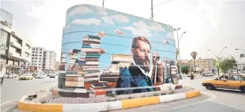  ?? ?? A mural of German sociologis­t Max Weber, drawn by Majed, on a concrete structure in Baghdad.