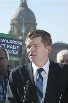  ?? ED KAISER/ EDMONTON JOURNAL ?? With the Legislatur­e in the background, Wildrose Leader Brian Jean releases his party’s balanced budget and savings plan during a news conference in Edmonton on Thursday.