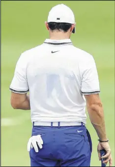  ?? WARREN LITTLE / GETTY IMAGES ?? Athletic tape is visible on Rory McIlroy’s back at The Players Championsh­ip. He says he is having discomfort and will undergo an MRI today.