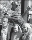  ?? AP/JAE C. HONG ?? Jackie Robinson’s widow Rachel Robinson (center) poses with her son David and daughter Sharon in front of a bronze statue of Robinson on Saturday outside Dodger Stadium in Los Angeles.