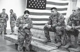  ?? Travis Dove / New York Times ?? Soldiers from the U.S. Army’s 82nd Airborne Division wait for a bus as they prepare to deploy to the Middle East at Fort Bragg in Fayettevil­le, N.C.