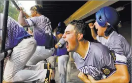  ?? Mattroth ?? The American Legion Blue Sox players Christian Sanford, second from right, and Gehrig Timmons, right, celebrate during a five-run ninth inning Monday that resulted in a 7-3 win over Bryant (Arkansas) and a berth in the American Legion World Series...