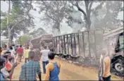  ?? PTI ?? Local residents look at trucks which were set on fire allegedly by members of the DNLA in Assam, on Friday.