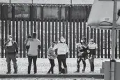  ?? Justin Hamel / Tribune News Service ?? Border Patrol agents apprehend a group of migrants near downtown El Paso following a congressio­nal border delegation visit on Monday.