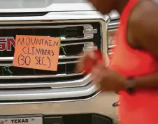  ??  ?? DaShana Blackburn and her neighbors have started coordinati­ng group workouts that wind through the community’s streets, creating stations in driveways that encourage participan­ts to do a series of exercises before running to the next station.