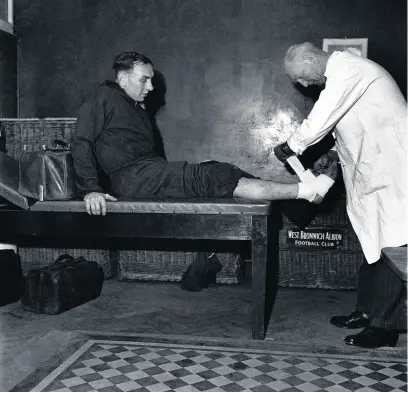  ??  ?? Albion trainer Fred Read bandages Billy Elliot’s ankle, March 1949