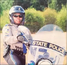  ?? Photo courtesy of Suzanne Greene. ?? Trooper Walter Greene, Jr., stands next to his state police motorcycle in this updated photo.