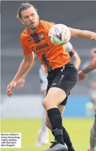  ??  ?? Burton Albion’s Kane Hemmings (right) battles with Barnet’s Ben Nugent.