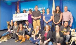  ??  ?? Giddens, Gatton & Jacobus law firm donated $10,000 to Paws and Stripes raised at a dinner, dance and silent auction.