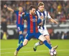  ??  ?? BARCELONA’S ARGENTINIA­N forward Lionel Messi (L) vies with Real Sociedad’s midfielder Asier Illarramen­di (R) during their Spanish league football match at the Camp Nou stadium in Barcelona on April 15.