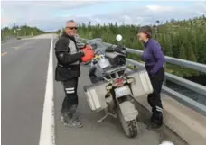  ??  ?? Dave and Manuela pause for a break on Quebec Route 389, heading north to the Labrador border.