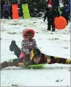  ?? The Associated Press ?? Jeremy Binstock gives his niece Olivia, 4, a sled ride on Capitol Hill in Washington, D.C., after a winter storm arrived in the region, Sunday.