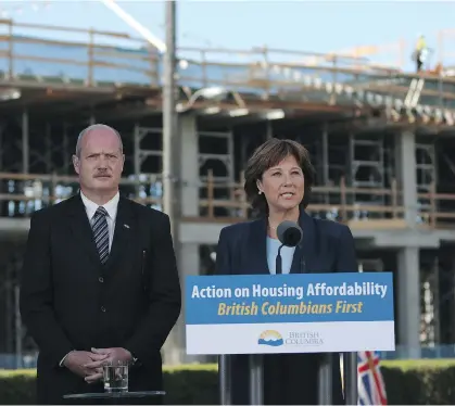  ?? CHAD HIPOLITO/THE CANADIAN PRESS ?? Premier Christy Clark and Finance Minister Michael de Jong discuss the details of the government’s Miscellane­ous Statutes (Housing Priority Initiative­s) Amendment Act presented Monday at the B.C. legislatur­e in Victoria.